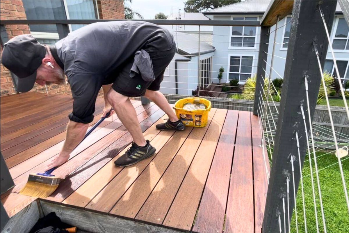 professional contractor refinishing deck