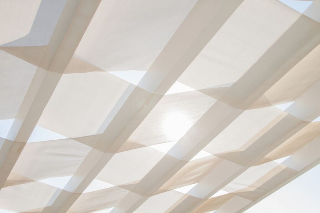 white transparent curtains and shade sail