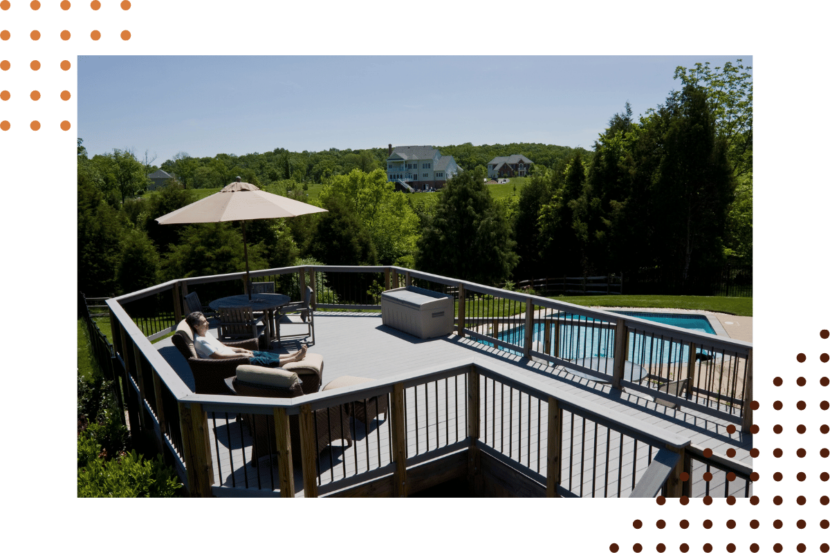 man relaxing on the deck patio above the pool