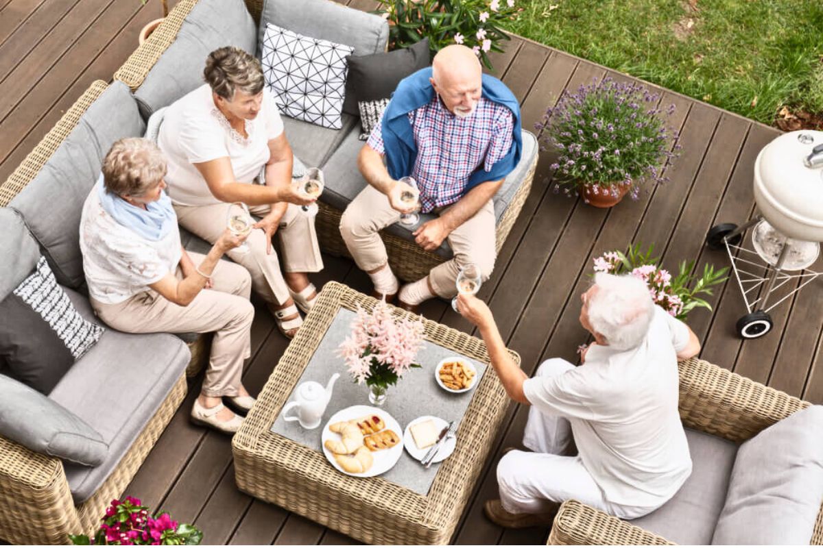 group off people eating together on backyard patio