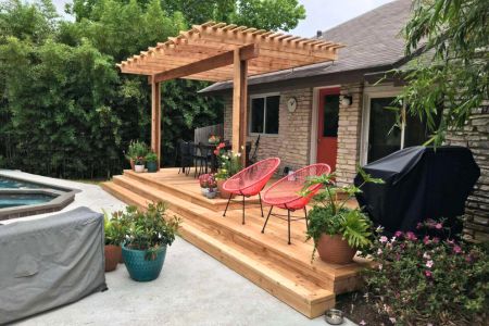 ground level deck pergola with chair